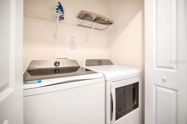 washroom with independent washer and dryer