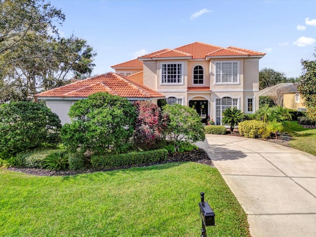 mediterranean / spanish-style home with a front lawn