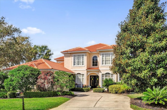 mediterranean / spanish-style home featuring french doors and a front yard