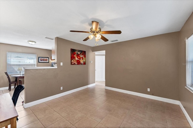 unfurnished room featuring light tile patterned floors and ceiling fan