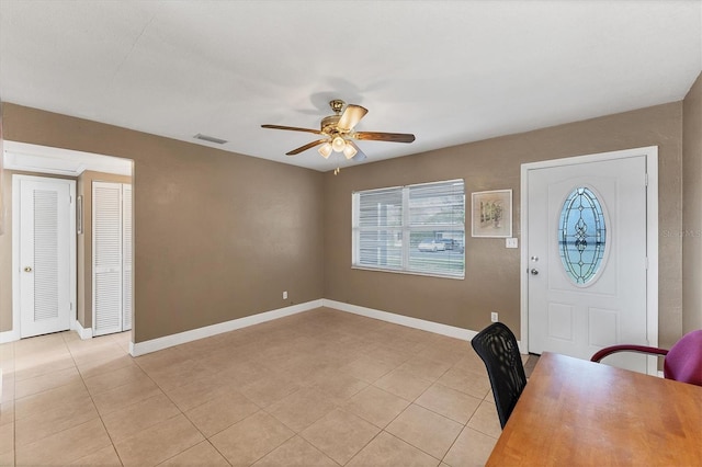 entrance foyer featuring light tile patterned flooring and ceiling fan