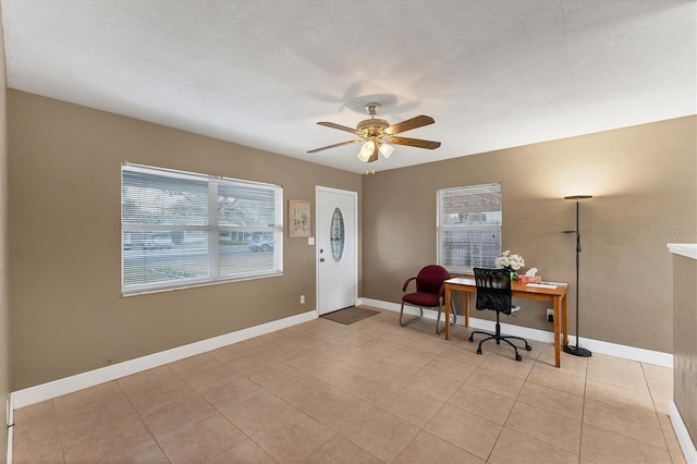 tiled office with ceiling fan and a textured ceiling