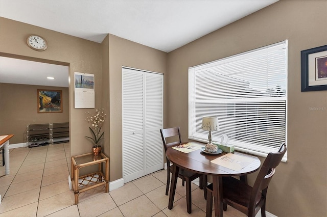 dining space featuring light tile patterned floors