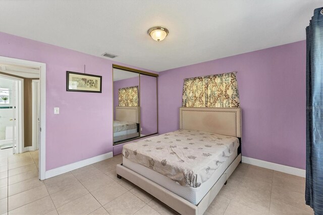 tiled bedroom featuring a closet