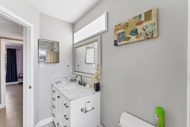 bathroom with tile patterned floors, vanity, and toilet