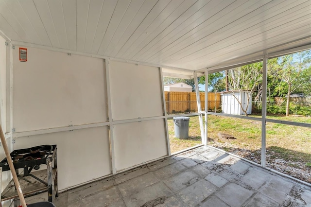 unfurnished sunroom with wooden ceiling