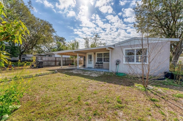 rear view of property with a yard and a patio