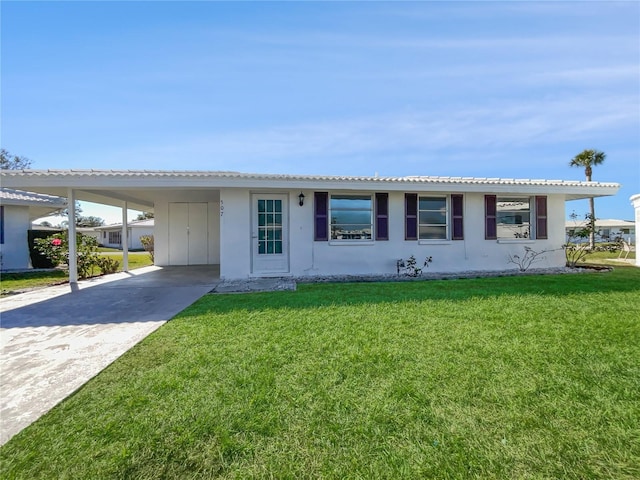 single story home featuring an attached carport, driveway, and a front lawn