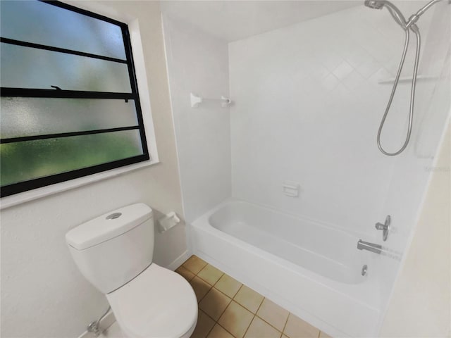 bathroom with a wealth of natural light, toilet,  shower combination, and tile patterned floors