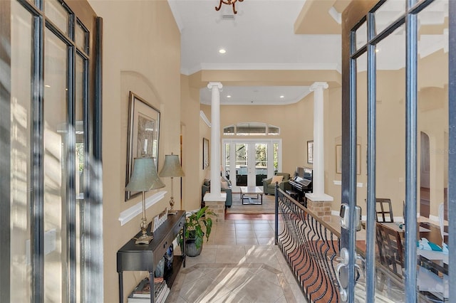 tiled foyer featuring french doors, recessed lighting, decorative columns, and crown molding