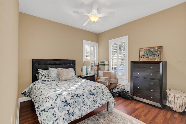 bedroom featuring dark wood-style floors, baseboards, and a ceiling fan