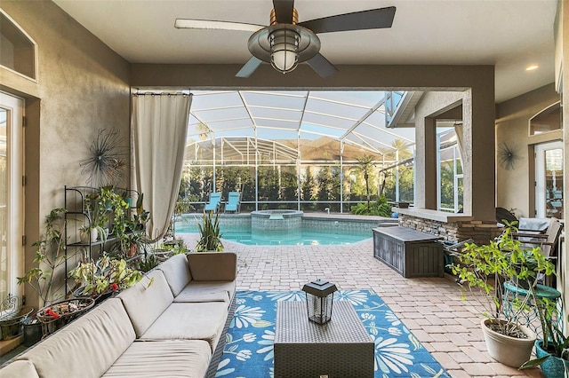 view of swimming pool with a ceiling fan, a lanai, a patio area, a pool with connected hot tub, and an outdoor living space