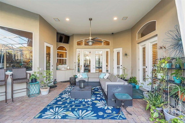 view of patio / terrace featuring visible vents, glass enclosure, ceiling fan, an outdoor hangout area, and french doors