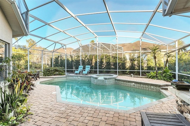 view of swimming pool with a lanai, a pool with connected hot tub, and a patio