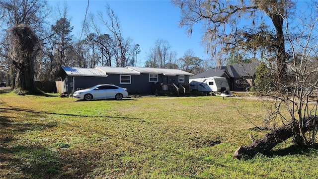 rear view of property featuring a yard