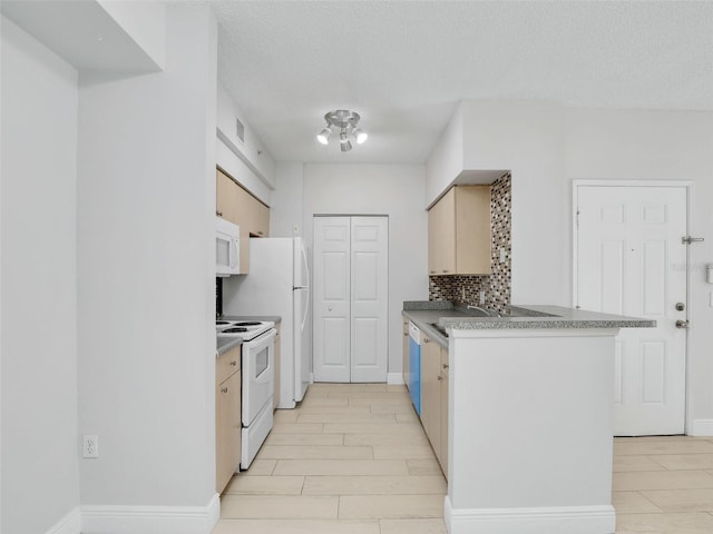 kitchen with sink, white appliances, tasteful backsplash, a textured ceiling, and light brown cabinets