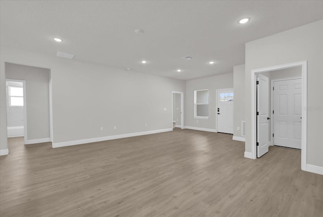 unfurnished living room featuring light hardwood / wood-style flooring