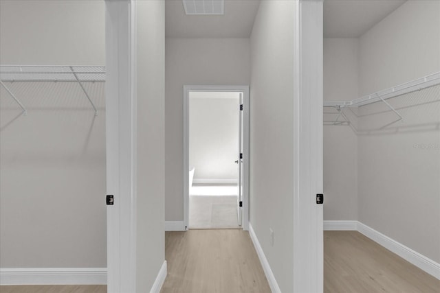 walk in closet featuring light hardwood / wood-style floors