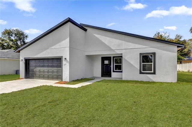 view of front of property featuring a garage and a front lawn