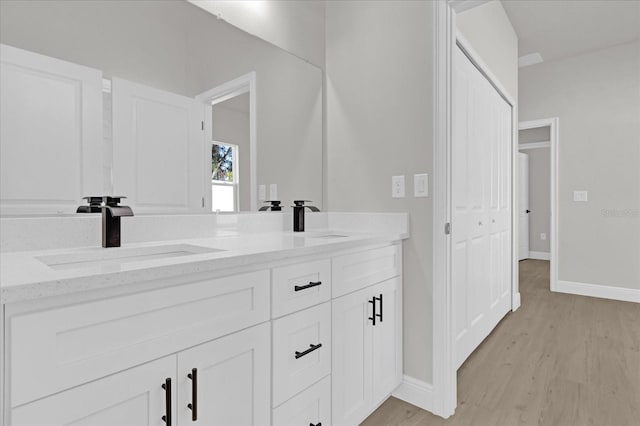 bathroom featuring vanity and wood-type flooring