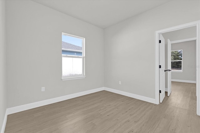 empty room featuring light hardwood / wood-style flooring and plenty of natural light