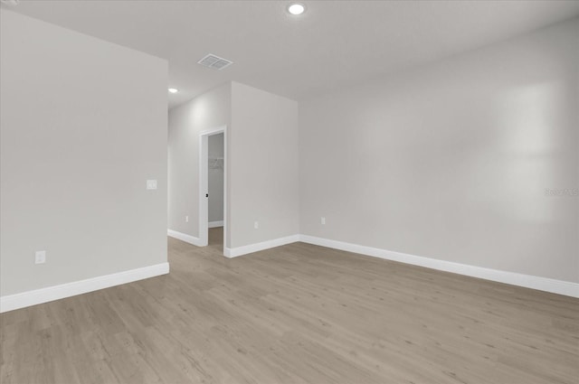 spare room with light hardwood / wood-style flooring