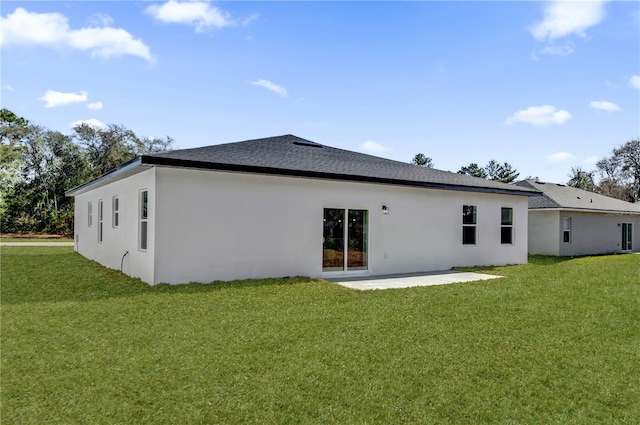 rear view of house with a yard and a patio