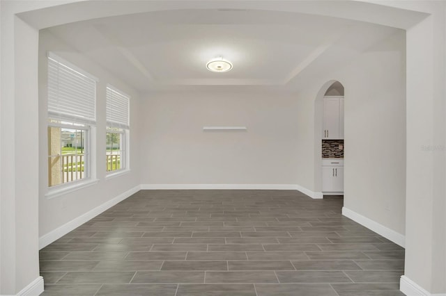 spare room with a raised ceiling