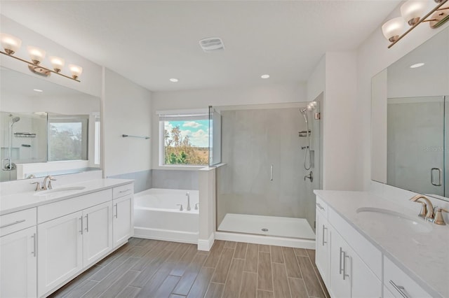 bathroom featuring vanity and separate shower and tub