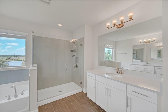 bathroom with shower with separate bathtub, a water view, and vanity