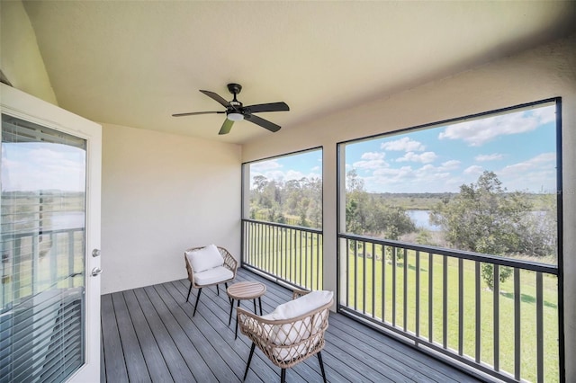 sunroom / solarium featuring ceiling fan