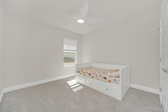 unfurnished bedroom featuring light colored carpet and ceiling fan