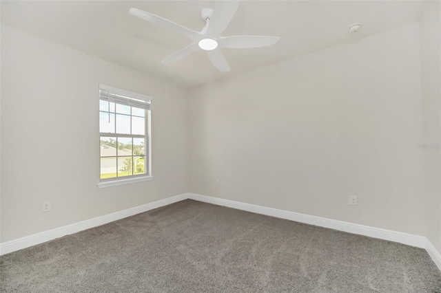 empty room with ceiling fan and carpet flooring