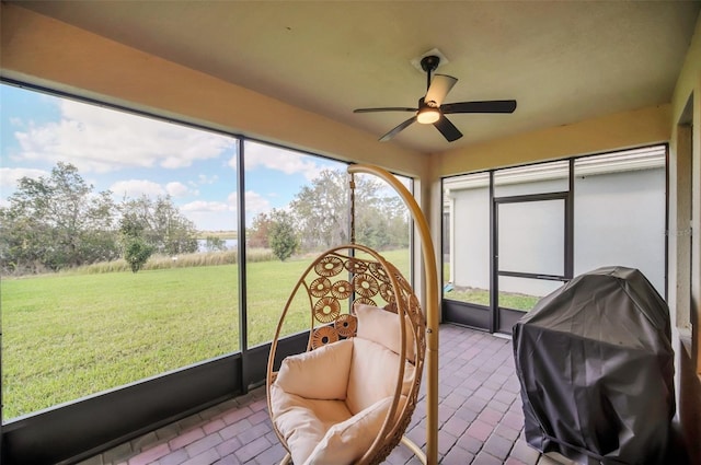 sunroom / solarium featuring ceiling fan