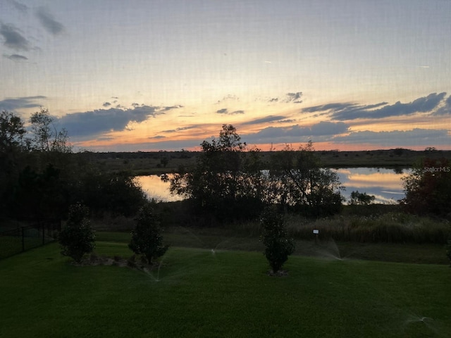 yard at dusk with a water view