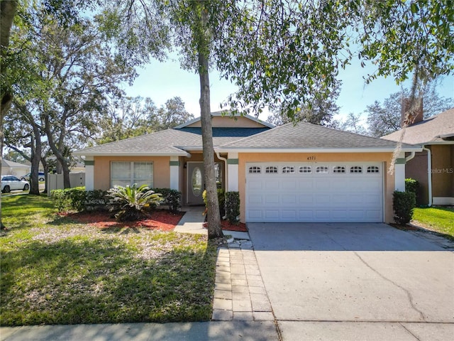 ranch-style house with a garage and a front yard