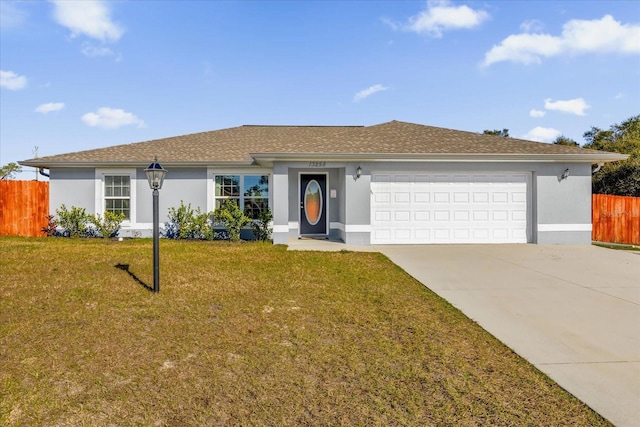 ranch-style house with a garage and a front lawn