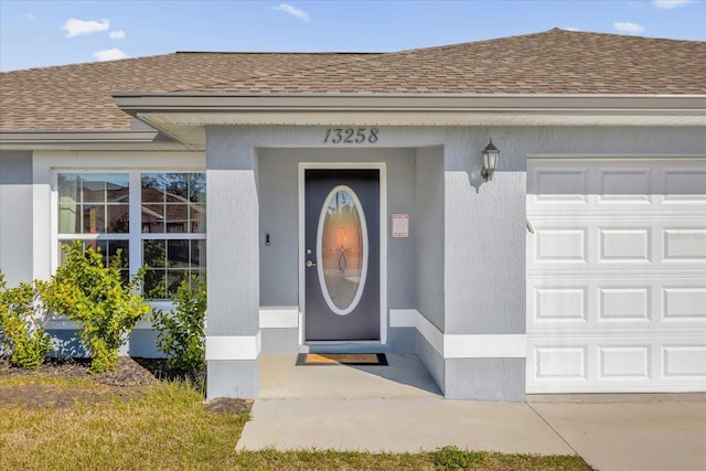 view of exterior entry with a garage