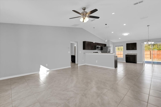 unfurnished living room with lofted ceiling, ceiling fan with notable chandelier, and light tile patterned flooring