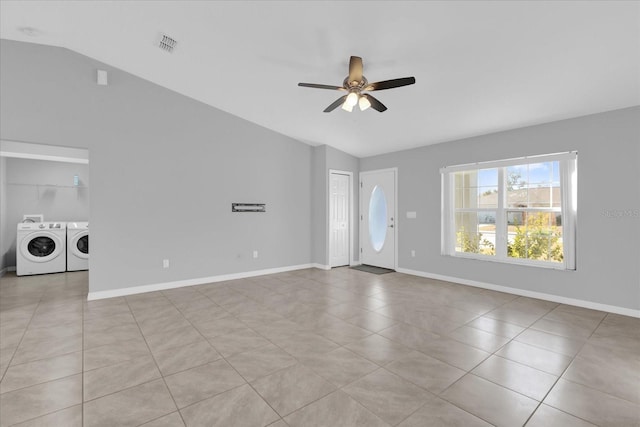 unfurnished living room featuring vaulted ceiling, washing machine and clothes dryer, and ceiling fan