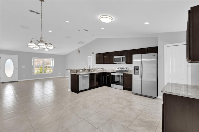 kitchen with vaulted ceiling, appliances with stainless steel finishes, pendant lighting, sink, and dark brown cabinets