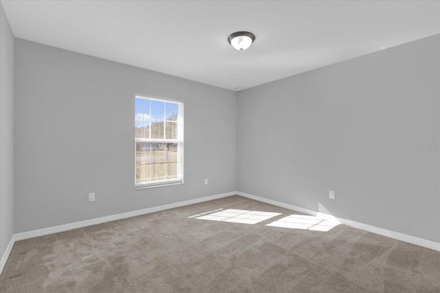 unfurnished room featuring light colored carpet