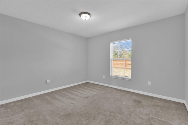 spare room featuring light colored carpet