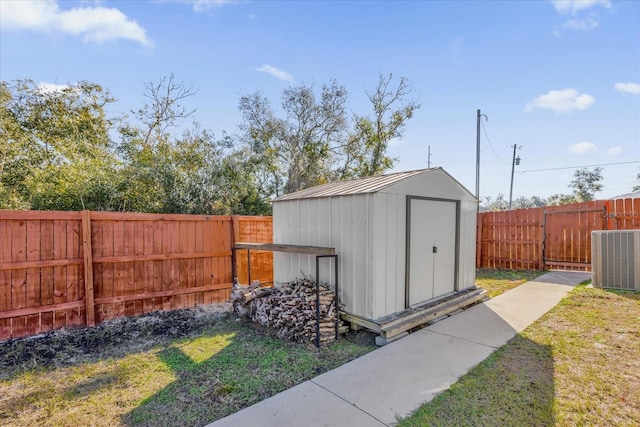 view of outdoor structure featuring central AC and a lawn