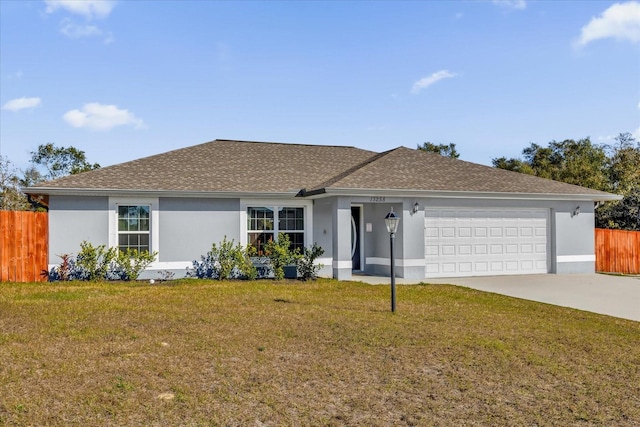 ranch-style home with a garage and a front lawn