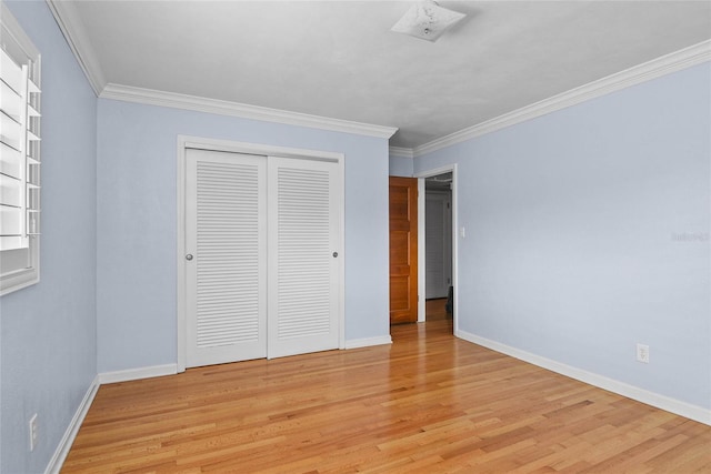625 Brechin Dr, Winter Park, FL 32792 - unfurnished bedroom featuring light wood-style floors, a closet, ornamental molding, and baseboards