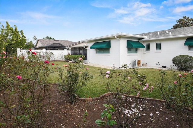 625 Brechin Dr, Winter Park, FL 32792 - rear view of house featuring a cooling unit, a lawn, and a sunroom
