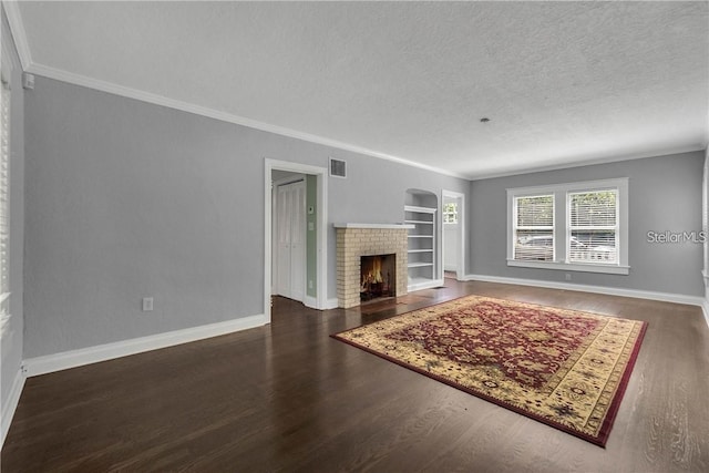 unfurnished living room with dark hardwood / wood-style flooring, a fireplace, ornamental molding, and a textured ceiling