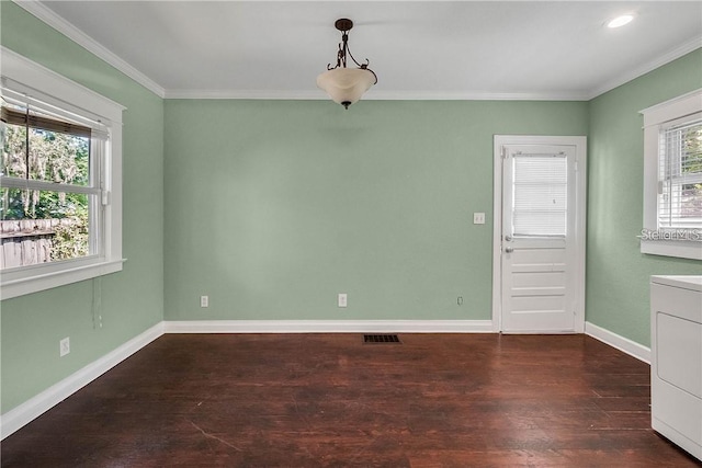 unfurnished room with dark hardwood / wood-style flooring, washer / clothes dryer, and ornamental molding