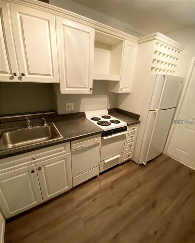 kitchen with white cabinetry, sink, and white appliances